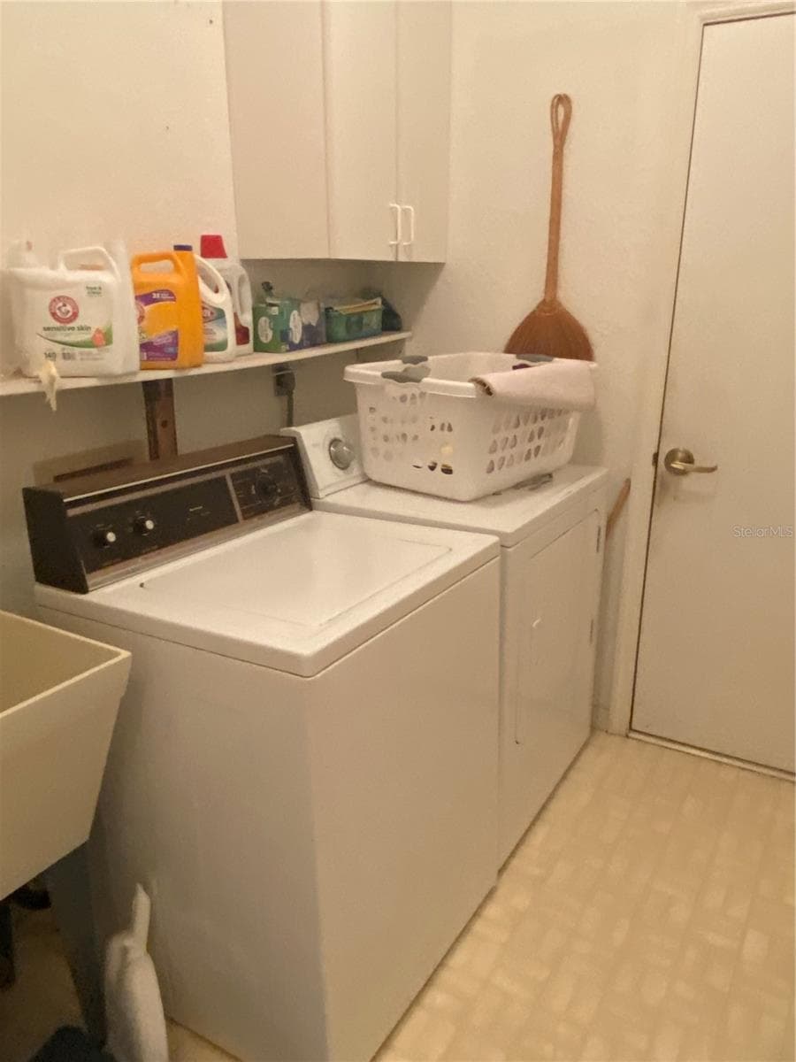 Laundry room indoor next to the garage door. Full size washer and dryer with ulitiy sink. - 11492 SW 82ND COURT RD, OCALA