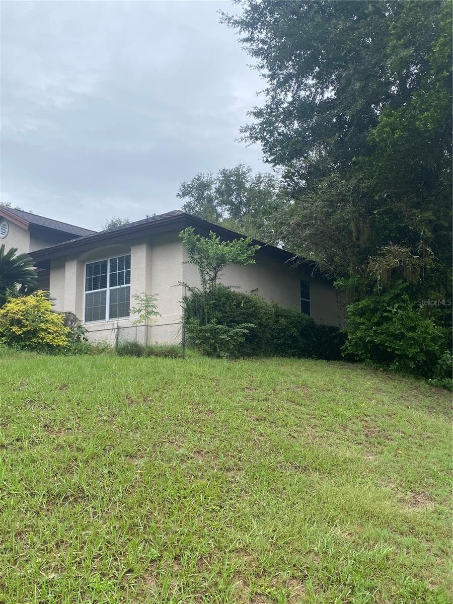 Side of the house, on a hill. - 11492 SW 82ND COURT RD, OCALA