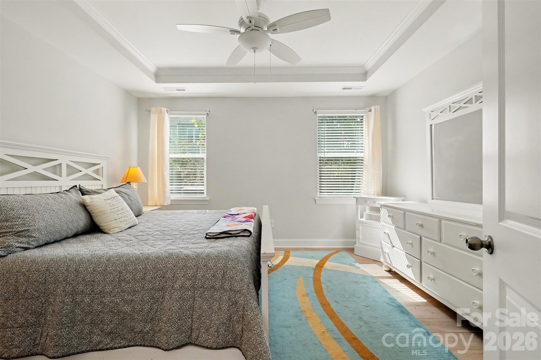 Primary bedroom with tray ceiling on the main level. - 4159 Black Court, Harris