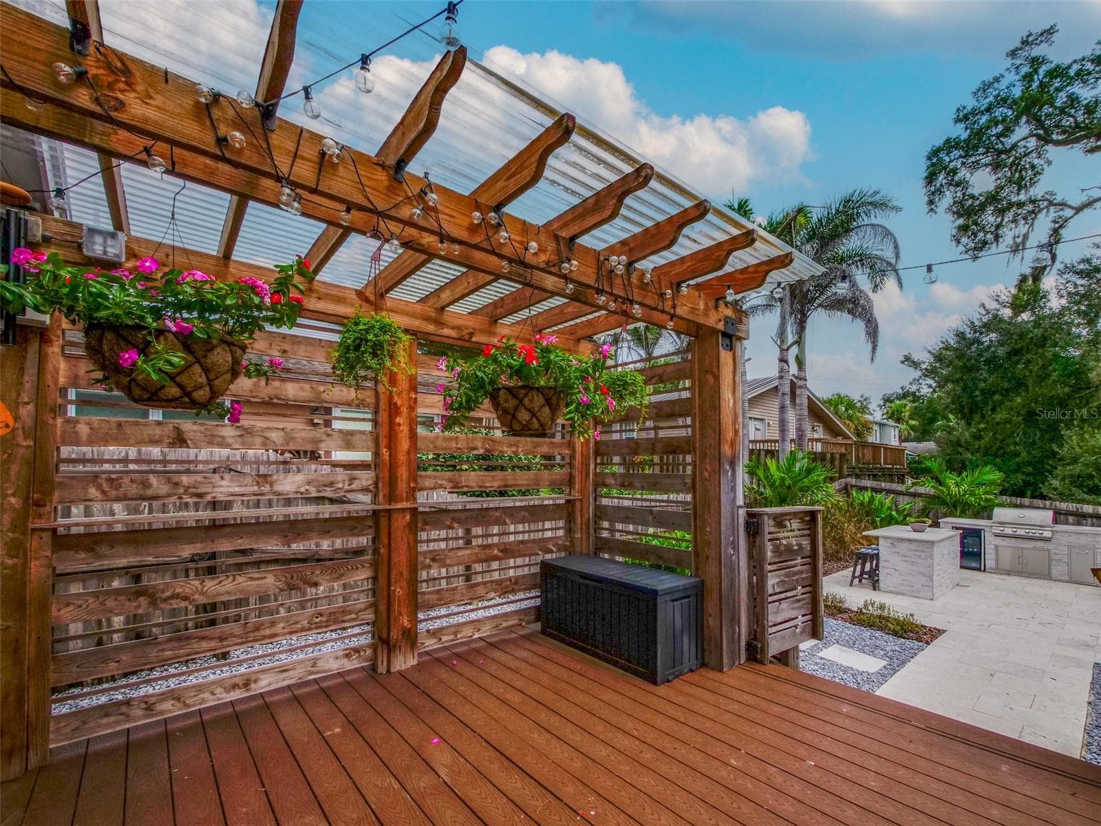 Rear deck with pergola, string lights, and view of the outdoor kitchen - 11 S LAWSONA BLVD, ORLANDO