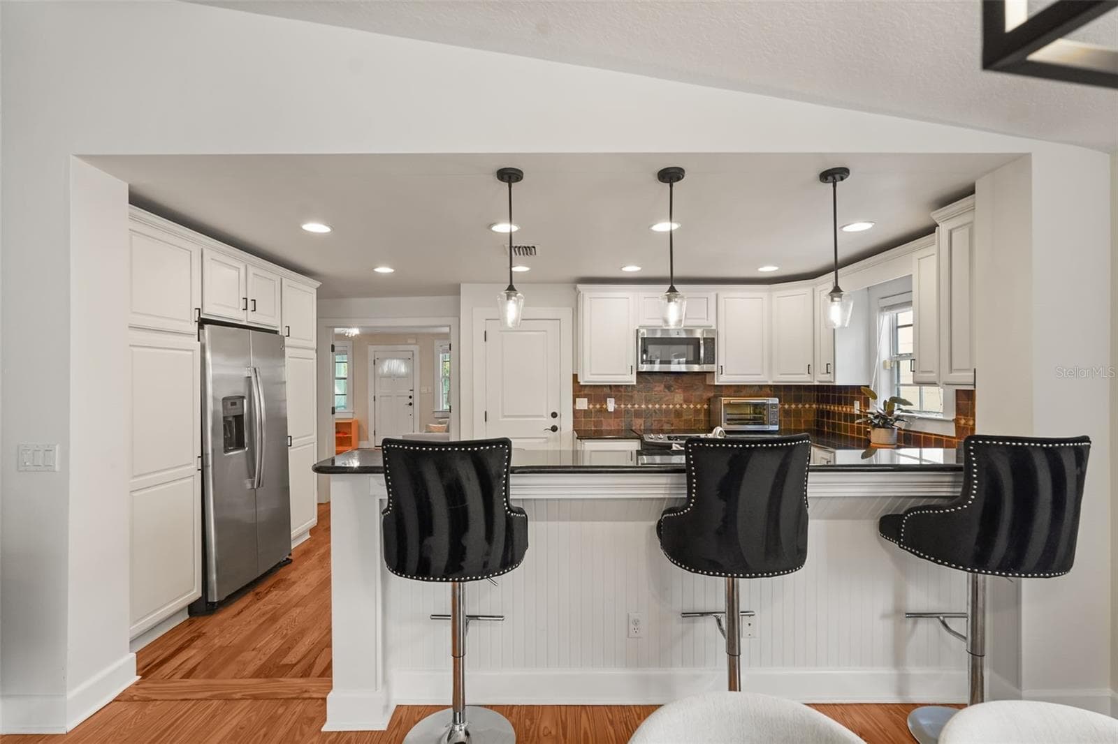 Kitchen with breakfast bar seating and pendant lighting - 11 S LAWSONA BLVD, ORLANDO