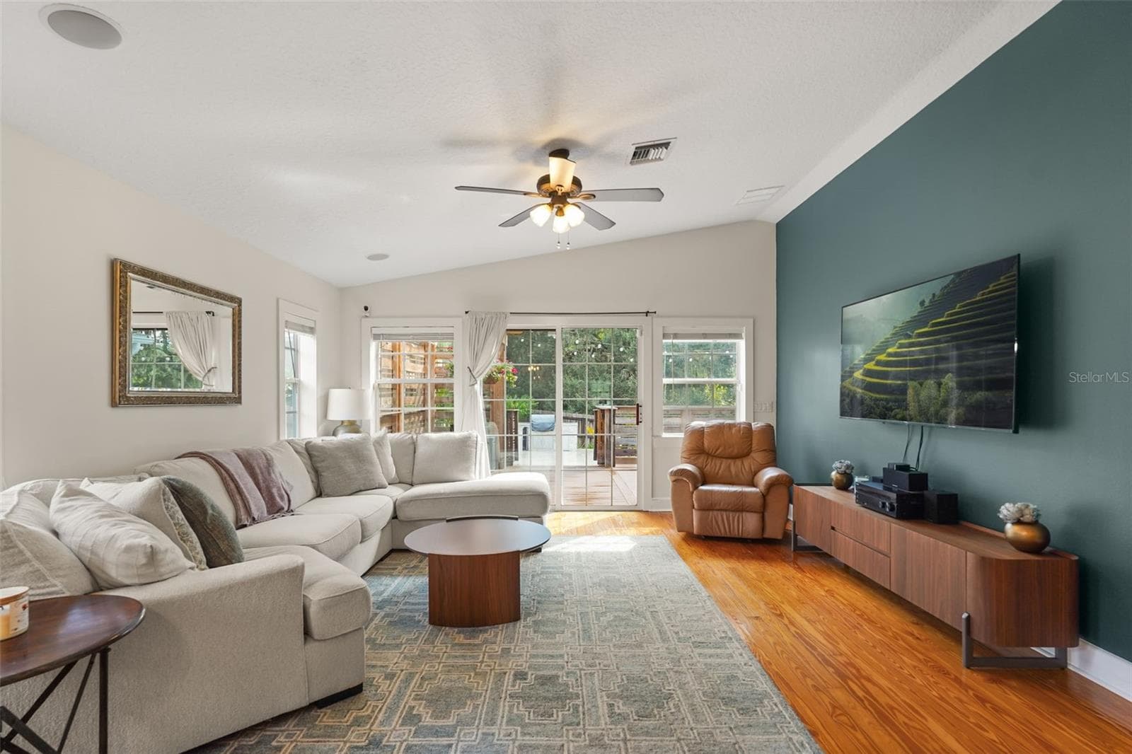 Living room with vaulted ceiling and accent wall - 11 S LAWSONA BLVD, ORLANDO