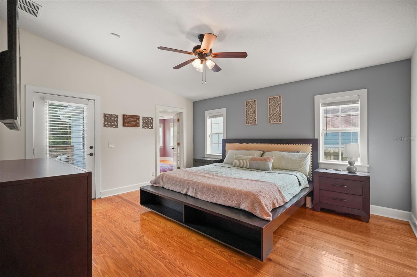 Primary bedroom with wood floors and door to the rear deck - 11 S LAWSONA BLVD, ORLANDO