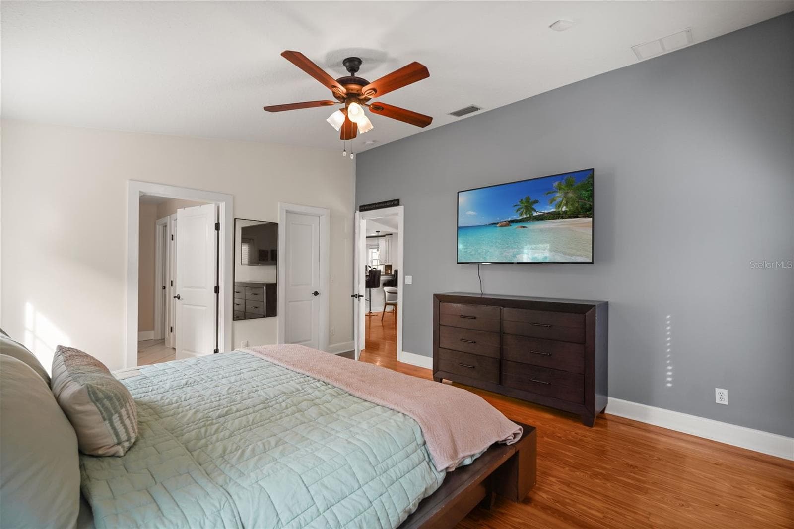 Primary bedroom with view to the primary bathroom and kitchen - 11 S LAWSONA BLVD, ORLANDO