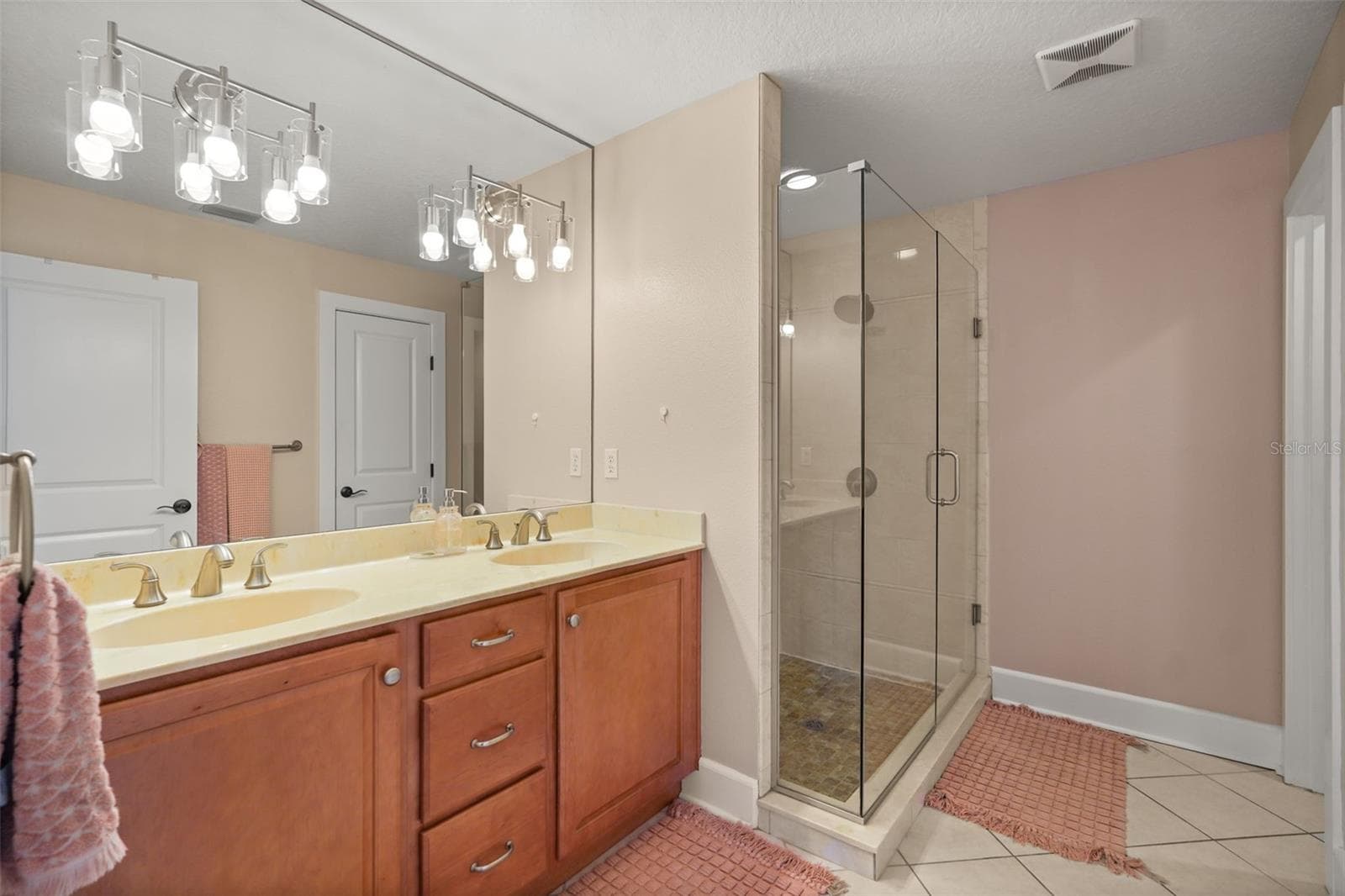 Primary bathroom with dual vanity and glass-enclosed shower - 11 S LAWSONA BLVD, ORLANDO