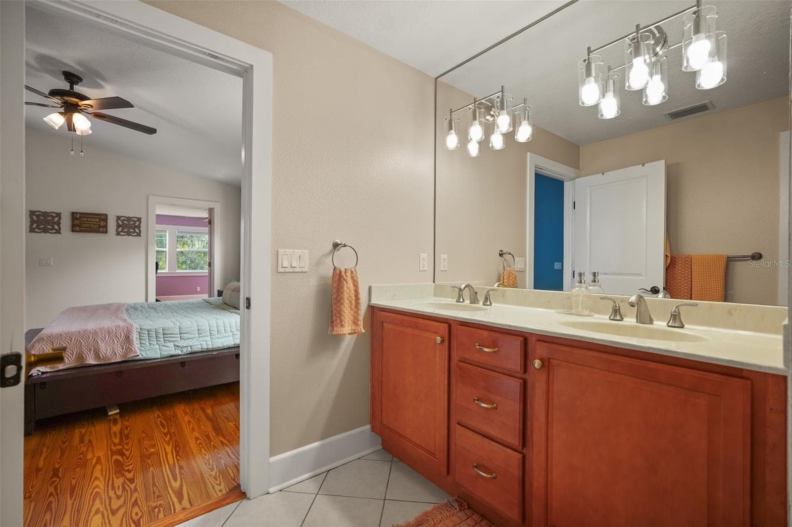 Primary bathroom dual vanity with view into the primary bedroom - 11 S LAWSONA BLVD, ORLANDO