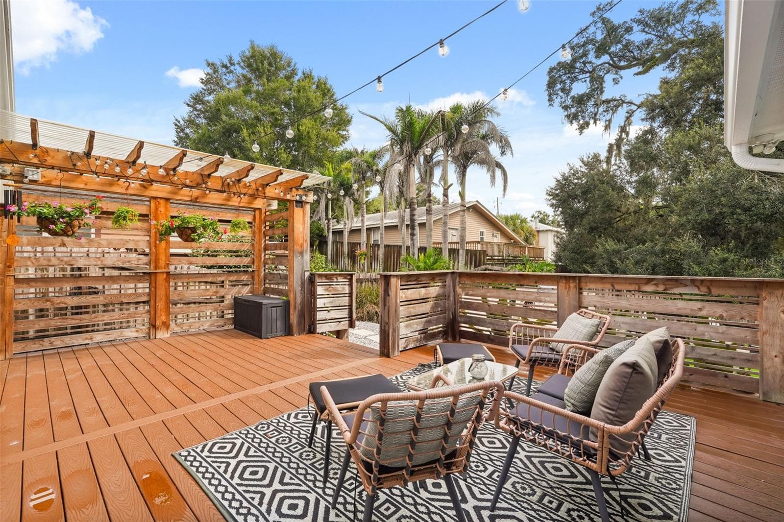 Rear deck seating area with pergola and string lights - 11 S LAWSONA BLVD, ORLANDO