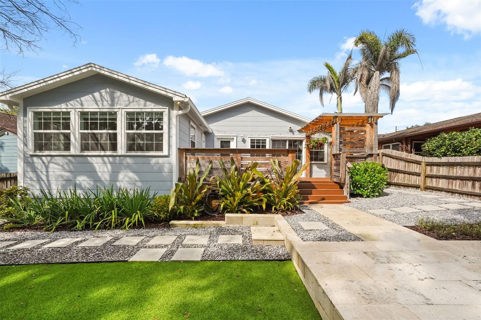 Rear exterior with landscaping and stepping stone path - 11 S LAWSONA BLVD, ORLANDO