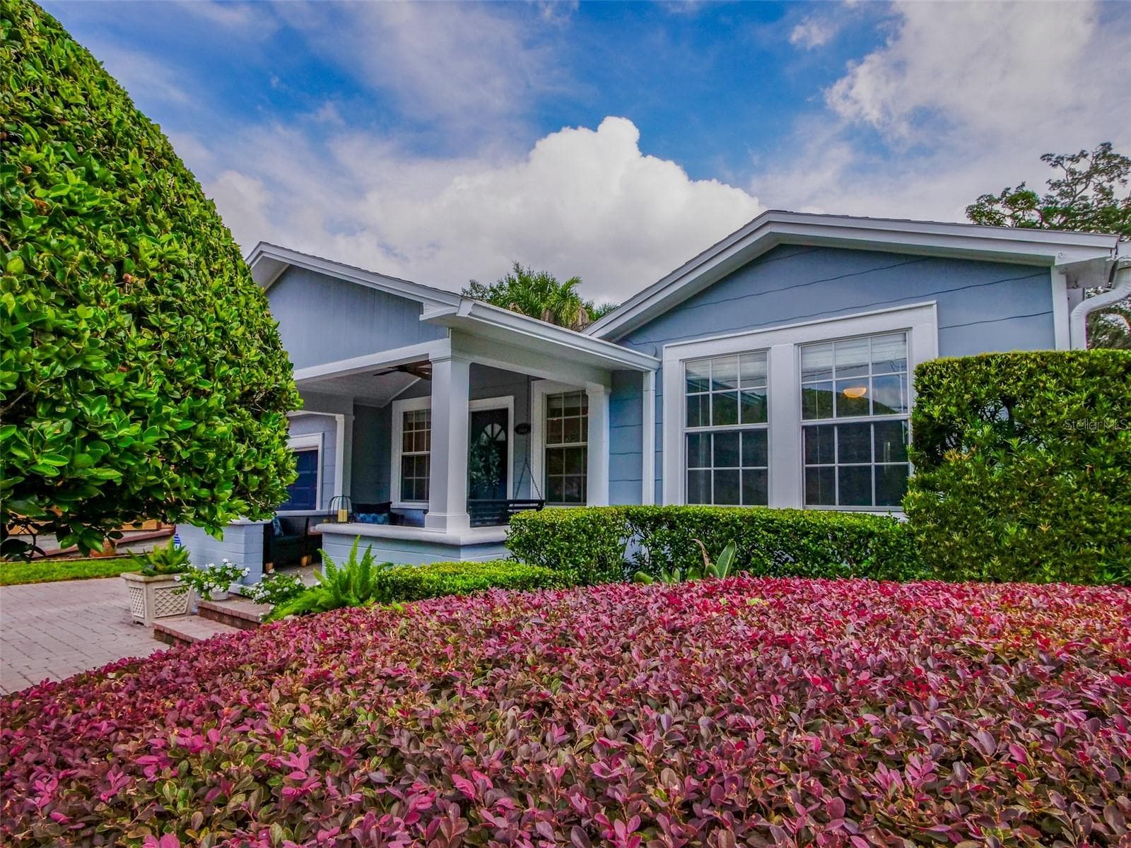 Front exterior with covered porch and flowering hedges - 11 S LAWSONA BLVD, ORLANDO