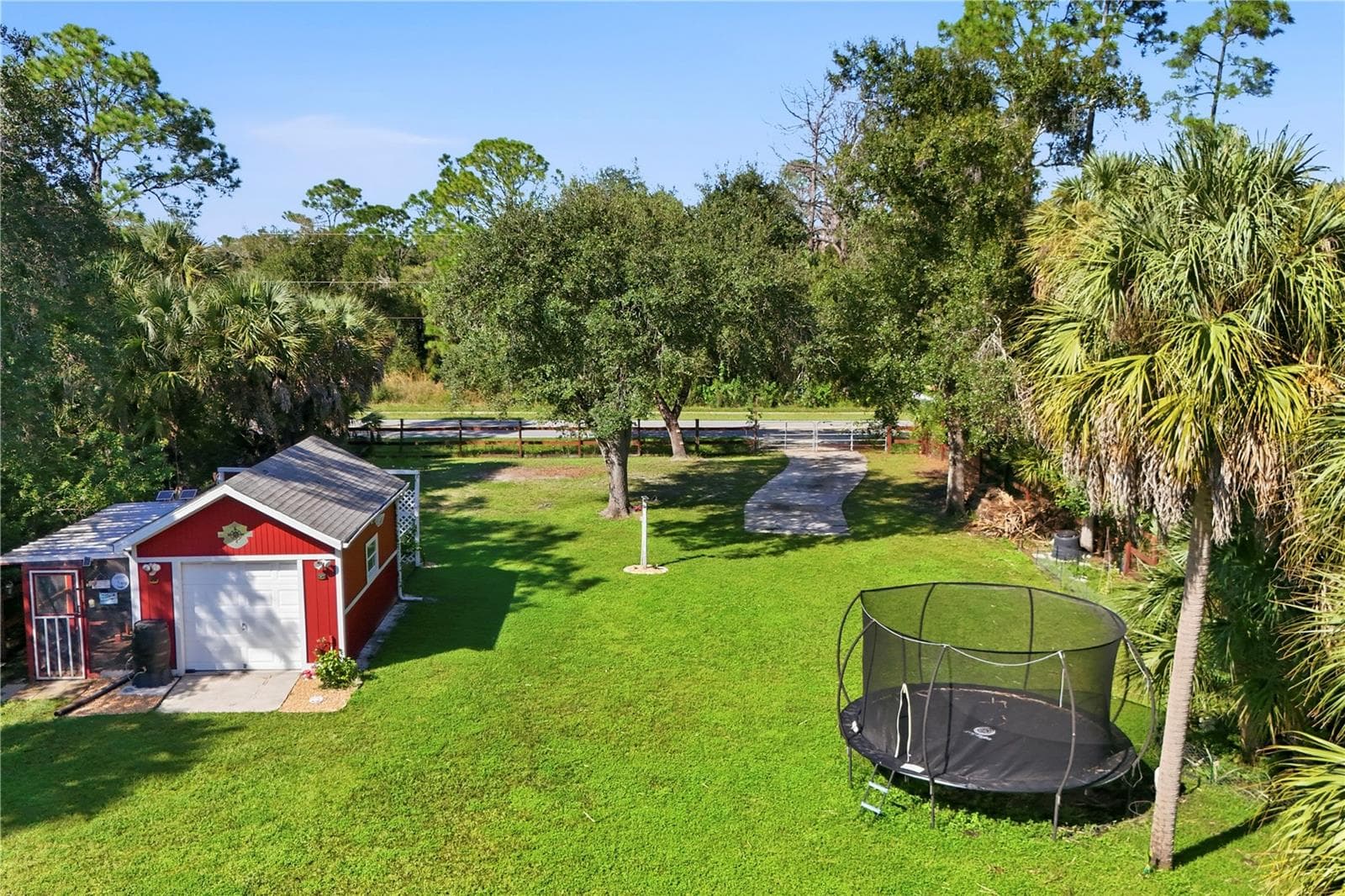 Backyard with free standing garage / workshop, chicken coop, rear gate and RV parking pad - 4732 FLINT DR, NORTH PORT