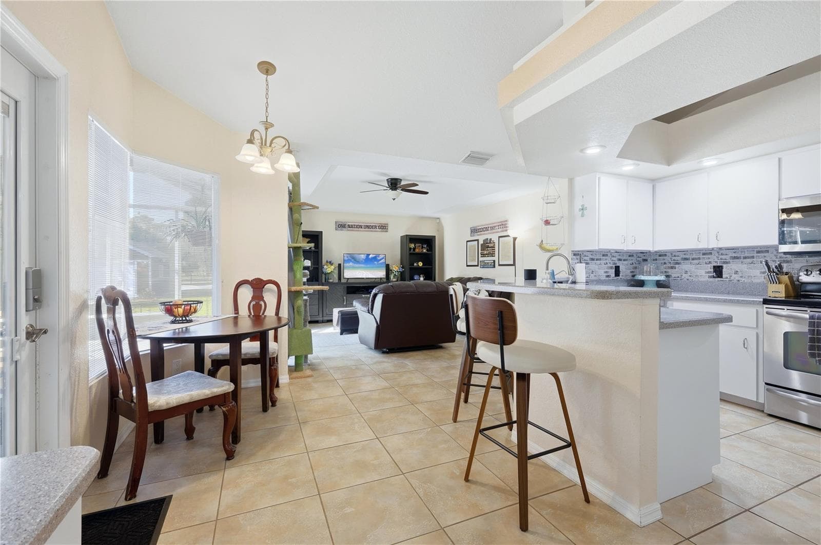 Kitchen with breakfast bar and dining area - 4732 FLINT DR, NORTH PORT