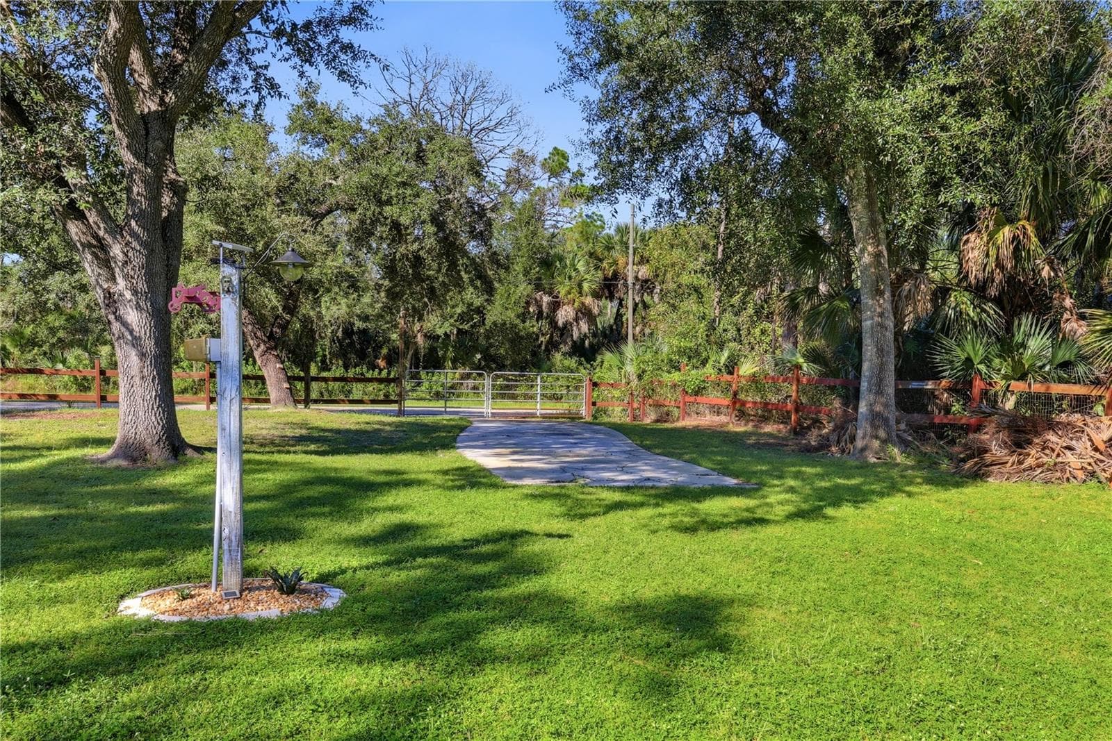 Rear entrance to property with gate. parking pad and RV hookup. - 4732 FLINT DR, NORTH PORT