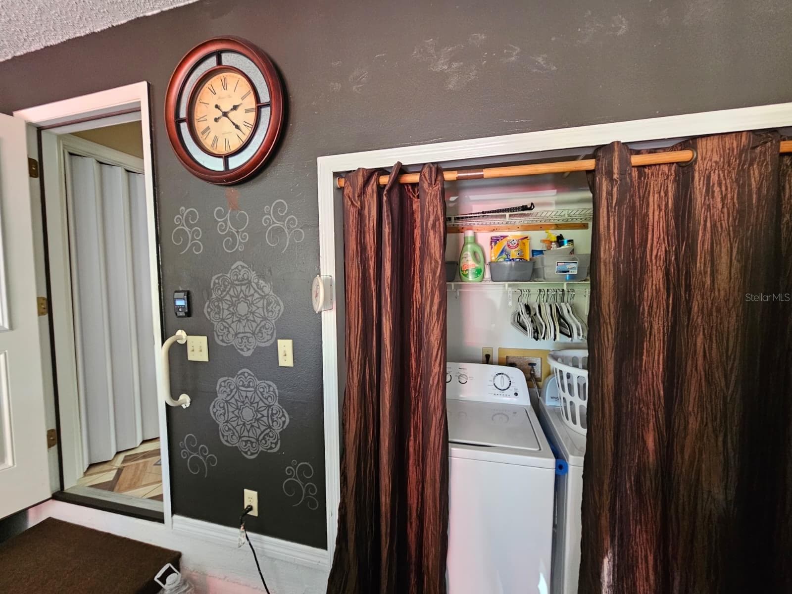 Laundry area in garage and garage door into home - 5036 SE 107TH PL, BELLEVIEW