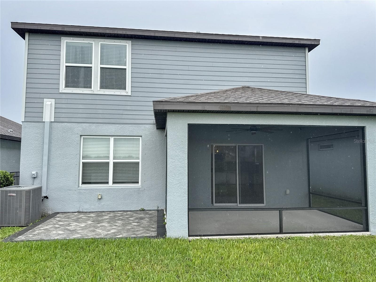 exterior back view of home showing covered and screened lanai - 8308 REEFBAY CV, PARRISH