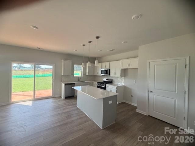 Kitchen features white surround cabinets and a gray island - 4025 Juno Drive, Charlotte