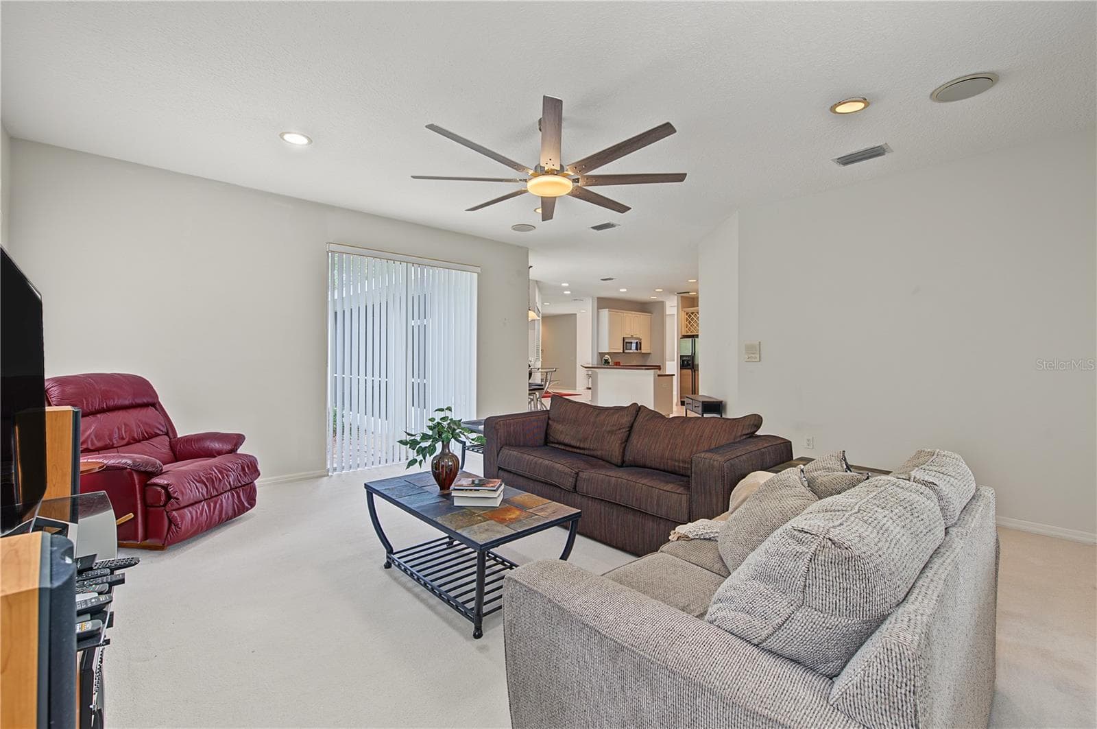 Oversized Family Room, with new ceiling fan and sliding doors to the back yard. - 915 LAKE THOMAS LN, LUTZ