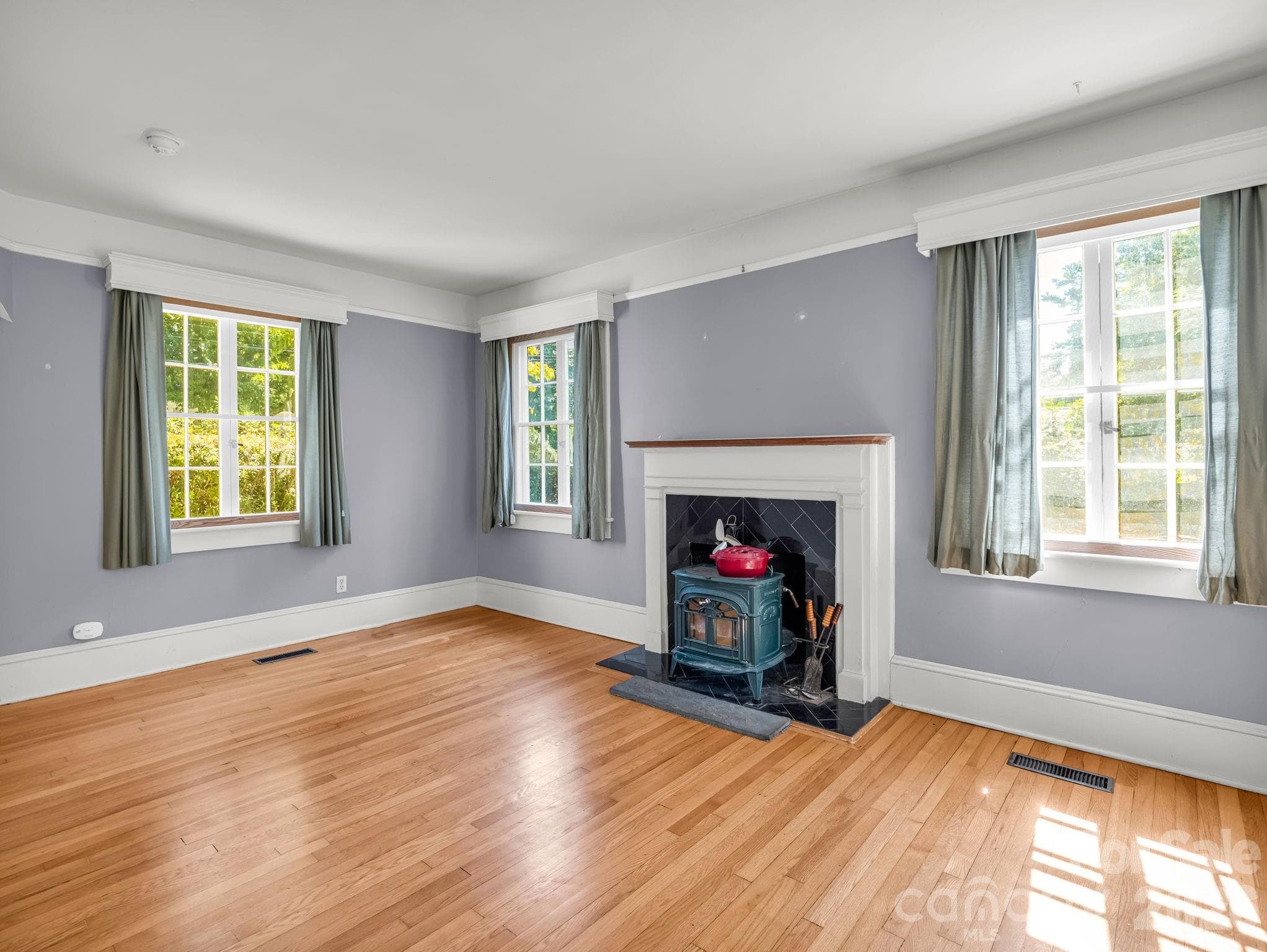 Living room featuring vermont casting wood stove, thick molding - 323 Blythe Street, Hendersonville
