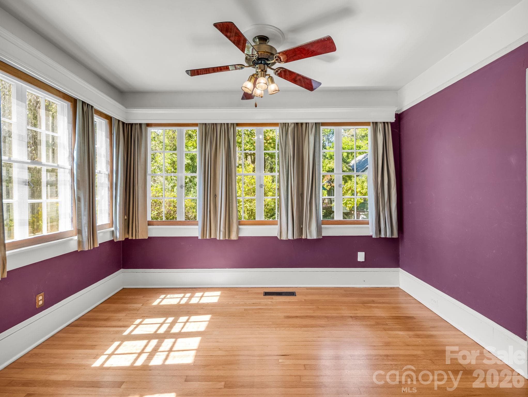 Sunroom with abundant windows and natural light, ceiling fan - 323 Blythe Street, Hendersonville
