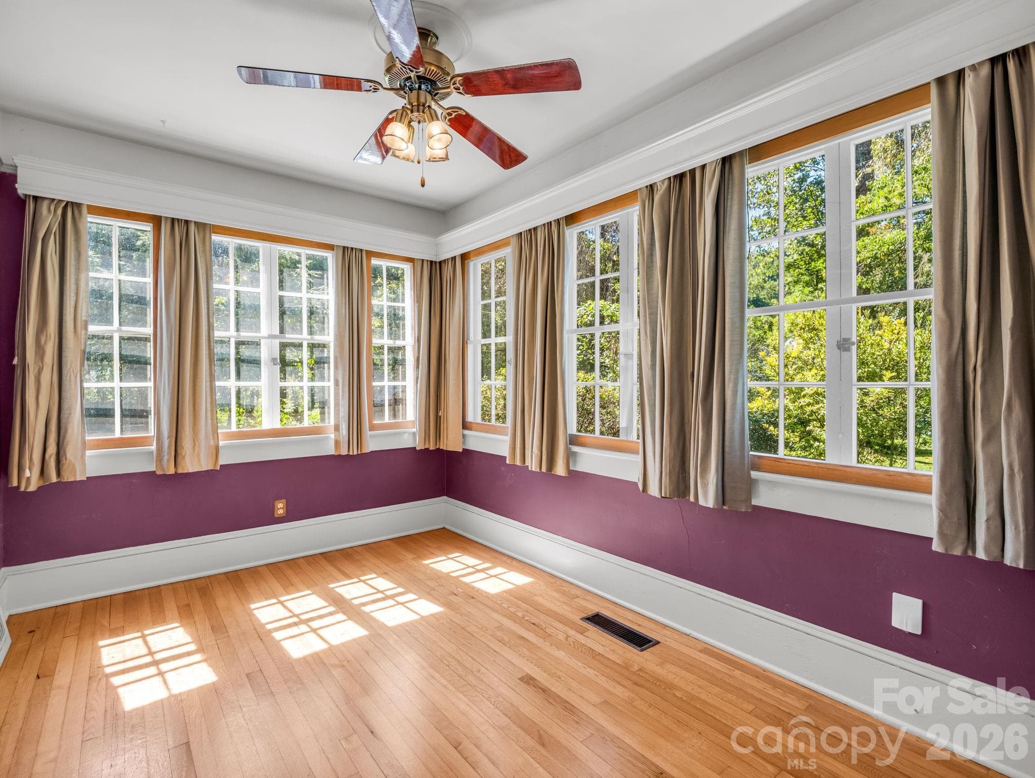 Sunroom with an abundance of windows and natural light - 323 Blythe Street, Hendersonville