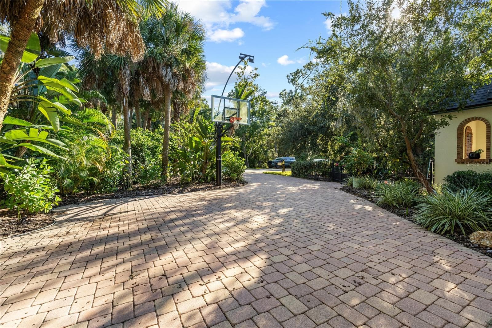 winding paver driveway, premium basketball hoop with evening arching light (2024) - 5903 RIVER FOREST CIR, BRADENTON