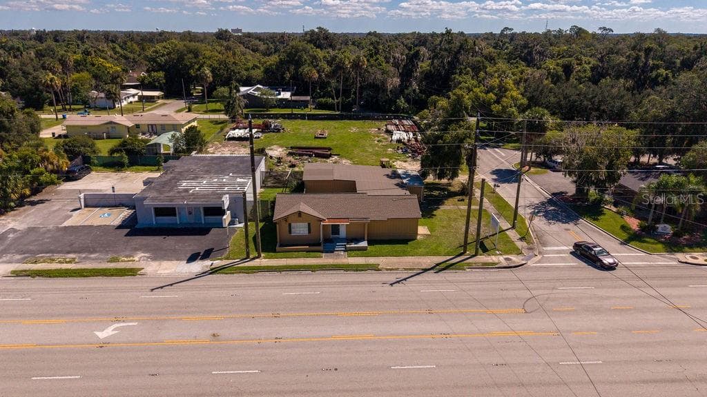 Aerial of front of building facing major thoroughfare 15-A. Building and vacant lot zoned B4. - 219 S SPRING GARDEN AVE, DELAND