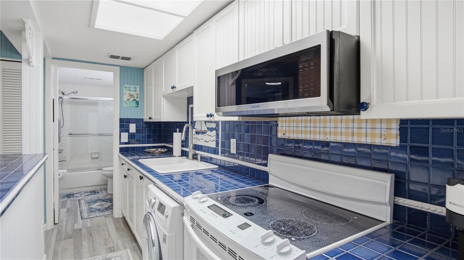 Kitchen area Stove & Washer - 20820 RIVER DR #B25, DUNNELLON