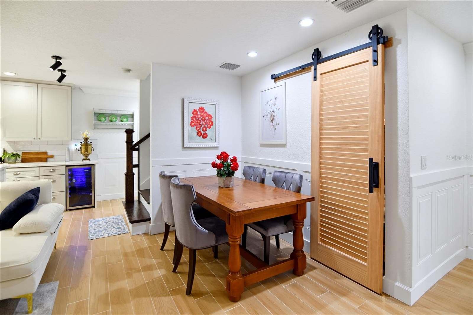 Dining area with stylish sliding barn door opening to an additional pantry and storage room. - 1611 CHESTNUT AVE, WINTER PARK