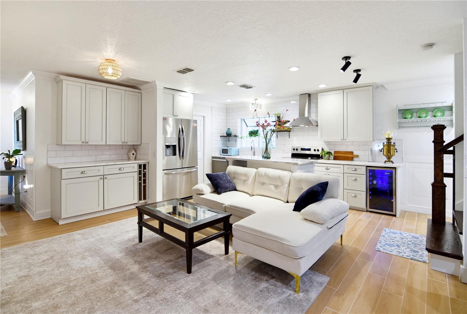 Spacious main living area with natural light, warm flooring, and an open-concept design. - 1611 CHESTNUT AVE, WINTER PARK