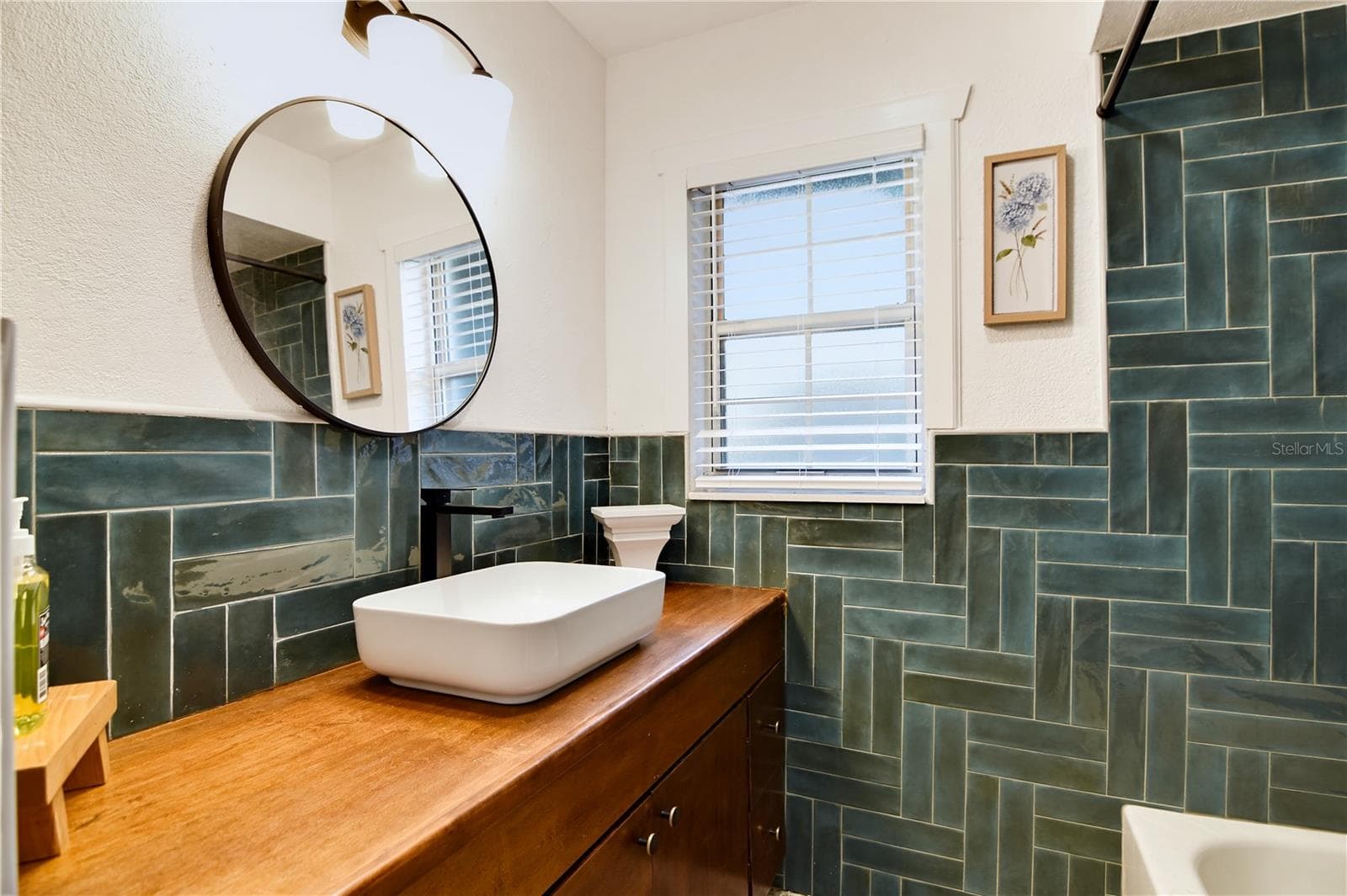 Beautifully appointed bathroom with distinctive tilework and updated fixtures. - 1611 CHESTNUT AVE, WINTER PARK