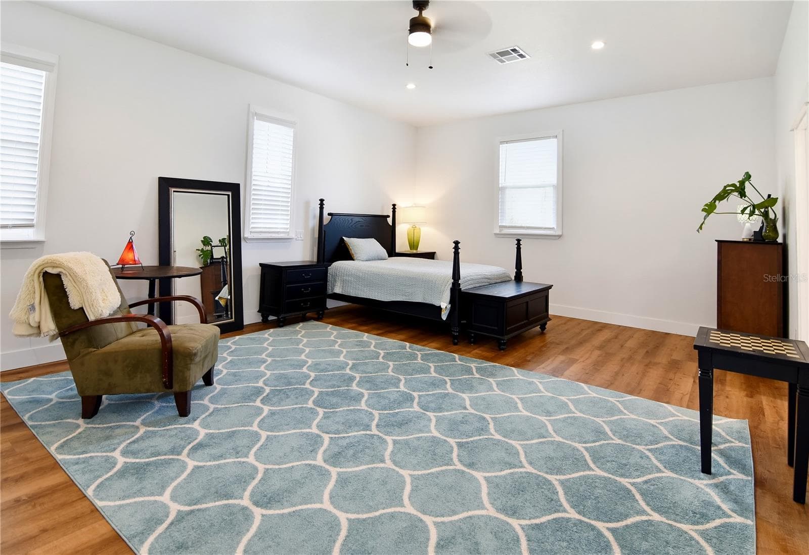 Private primary retreat featuring generous proportions and attractive wood-look flooring. - 1611 CHESTNUT AVE, WINTER PARK