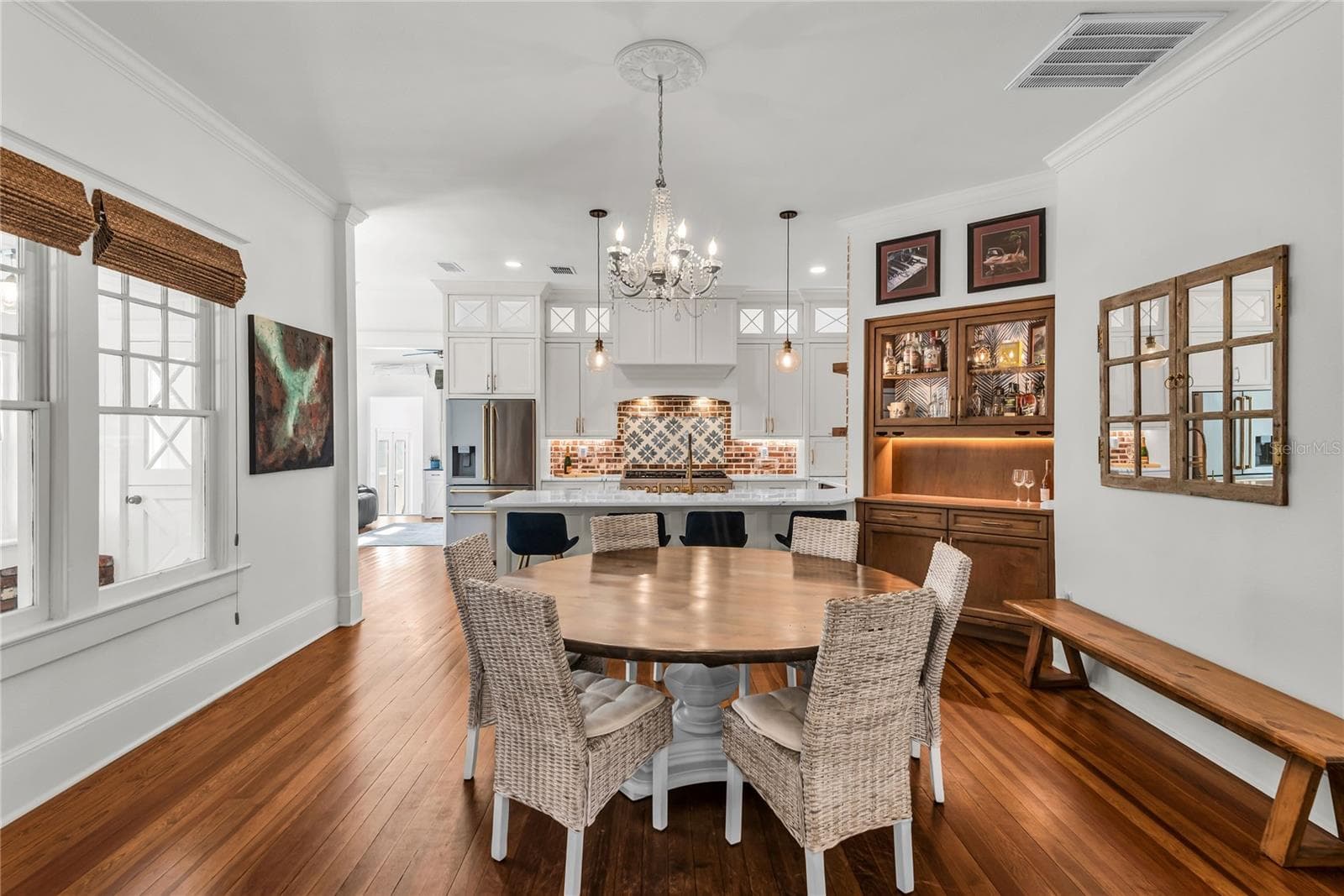 The Formal Dining room offers a seamless connection to the kitchen while maintaining its own distinct character. A custom built-in beverage bar serves as both a stunning focal point and dedicated space for serving coffee or refreshments. - 234 N LAKEVIEW AVE, WINTER GARDEN