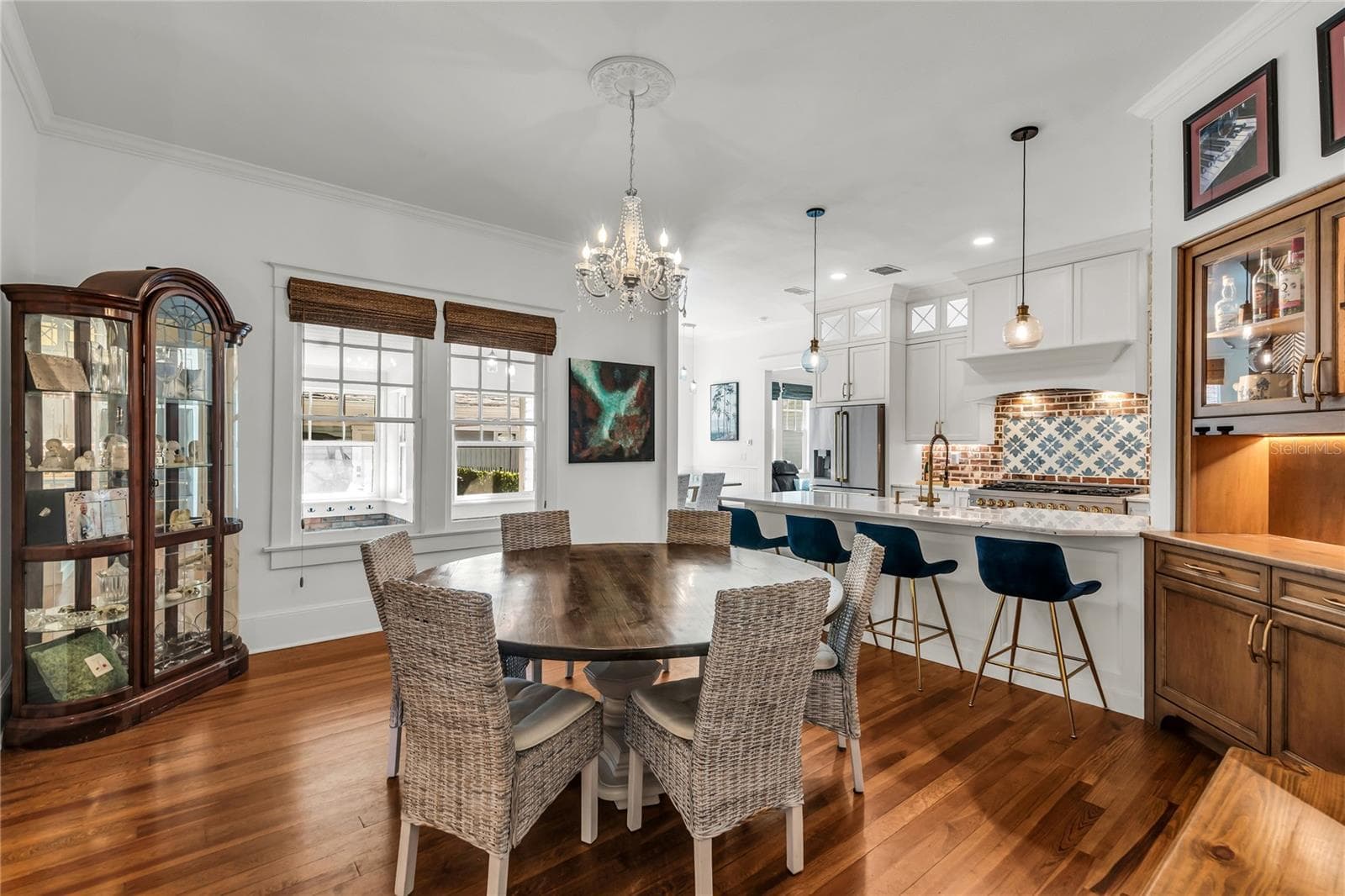 The Formal Dining room offers a seamless connection to the kitchen while maintaining its own distinct character. A custom built-in beverage bar serves as both a stunning focal point and dedicated space for serving coffee or refreshments. - 234 N LAKEVIEW AVE, WINTER GARDEN