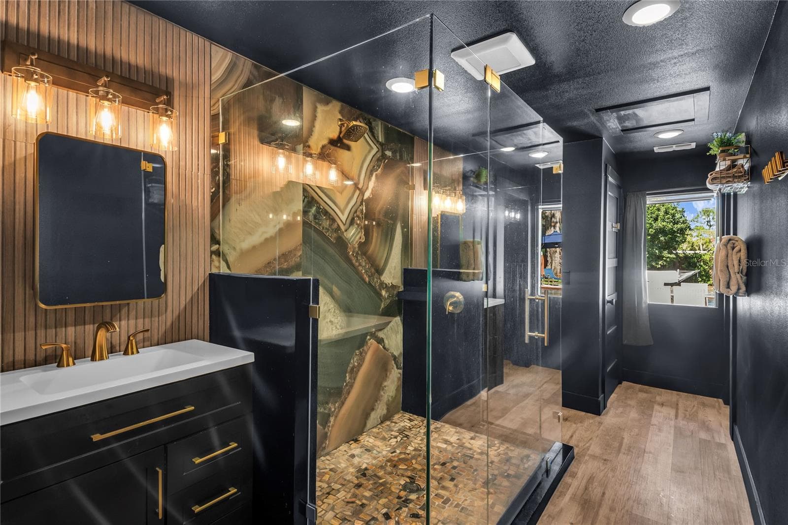 Oversized spa inspired bathroom features with dual vanities, two private water closets, a large glass-enclosed shower and elevated finishes throughout - 234 N LAKEVIEW AVE, WINTER GARDEN
