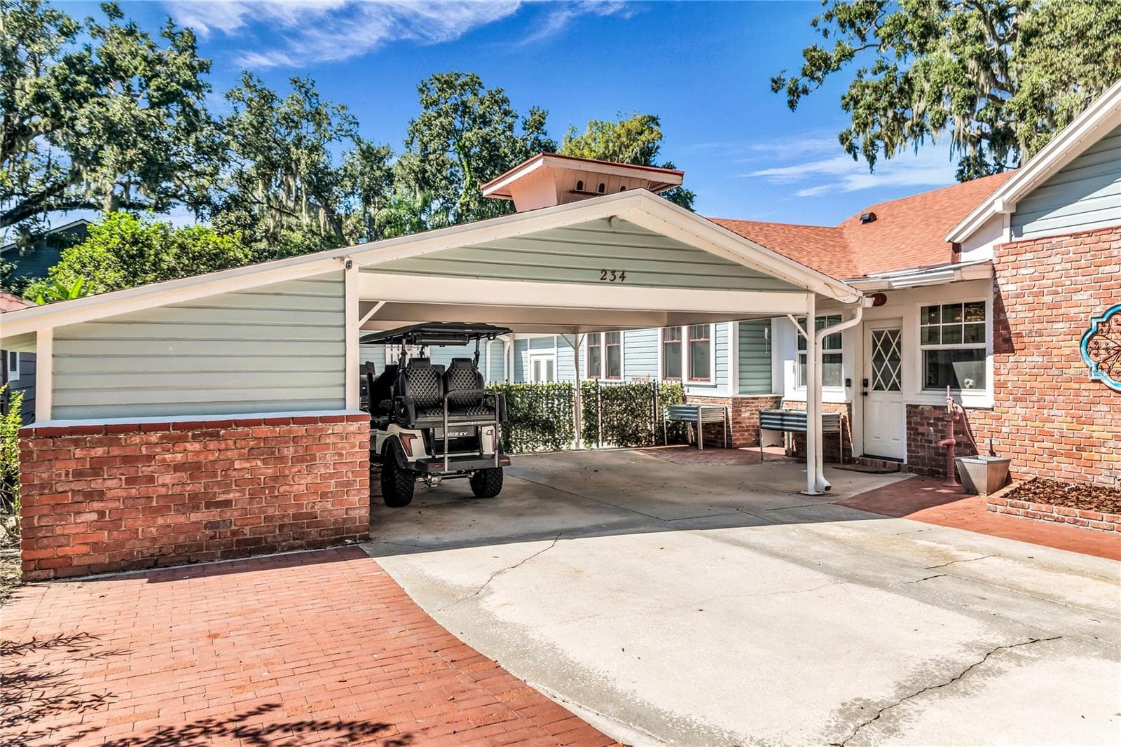 Double Carport includes both a Tesla and golf cart charging station as well as a large storage closet equipped with power and a shop desk. - 234 N LAKEVIEW AVE, WINTER GARDEN