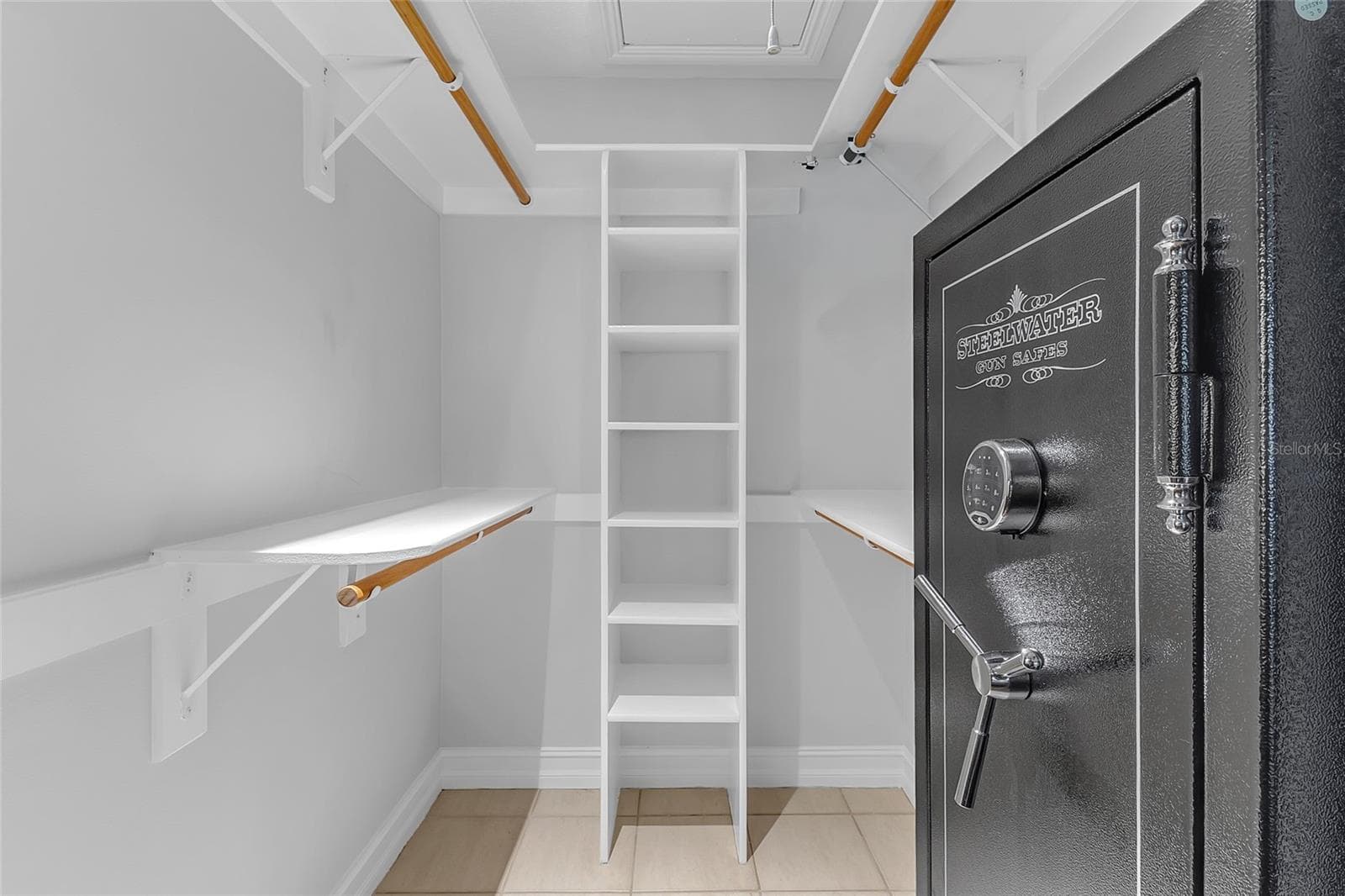 Primary Bedroom Walk-In Closet with Pull-Down Stairs Providing Access to Additional Attic Storage and Closet Space - 4113 FAIRVIEW VISTA PT #311, ORLANDO