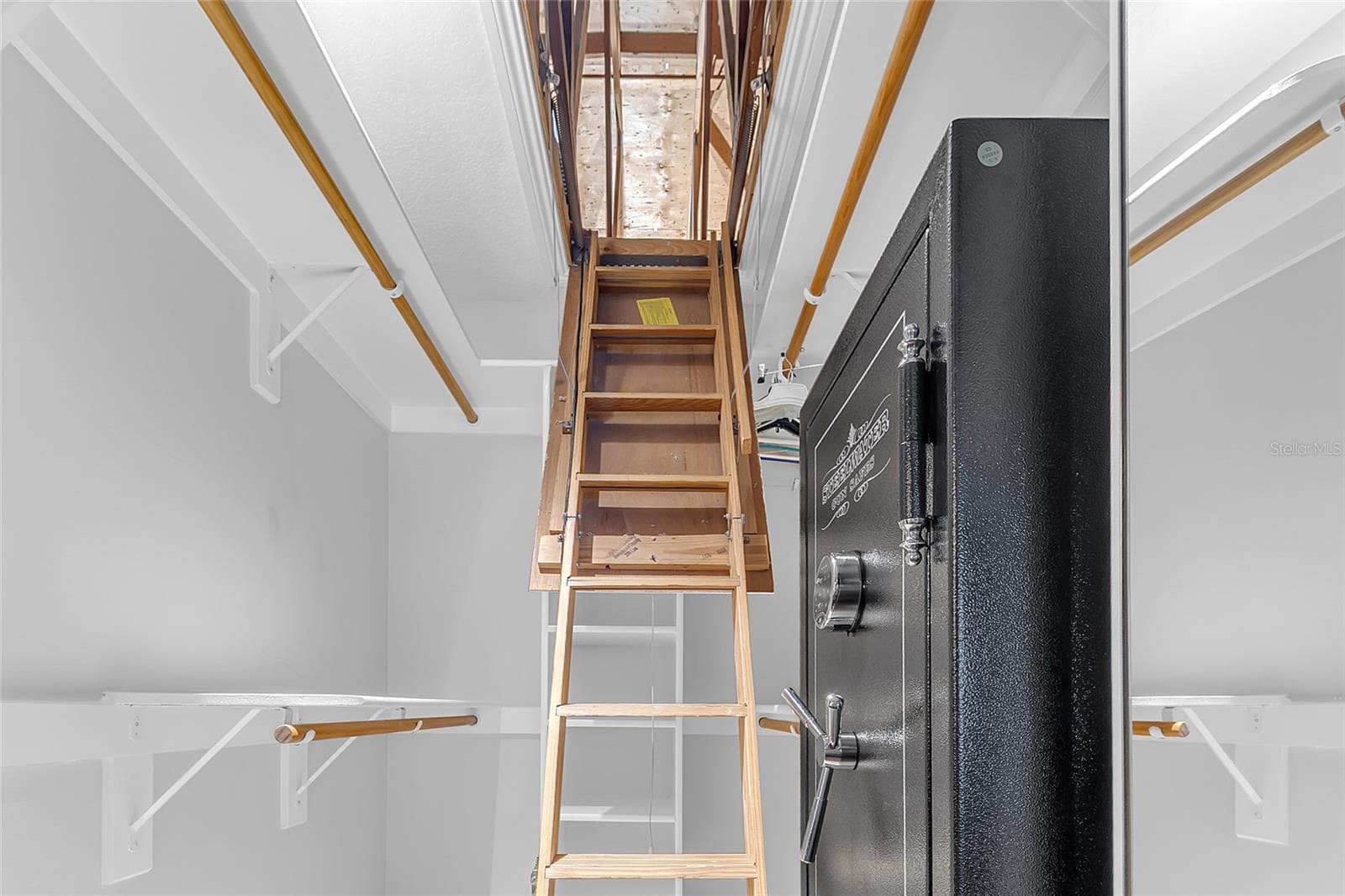 Primary Bedroom Walk-In Closet with Pull-Down Stairs Providing Access to Additional Attic Storage and Closet Space - 4113 FAIRVIEW VISTA PT #311, ORLANDO