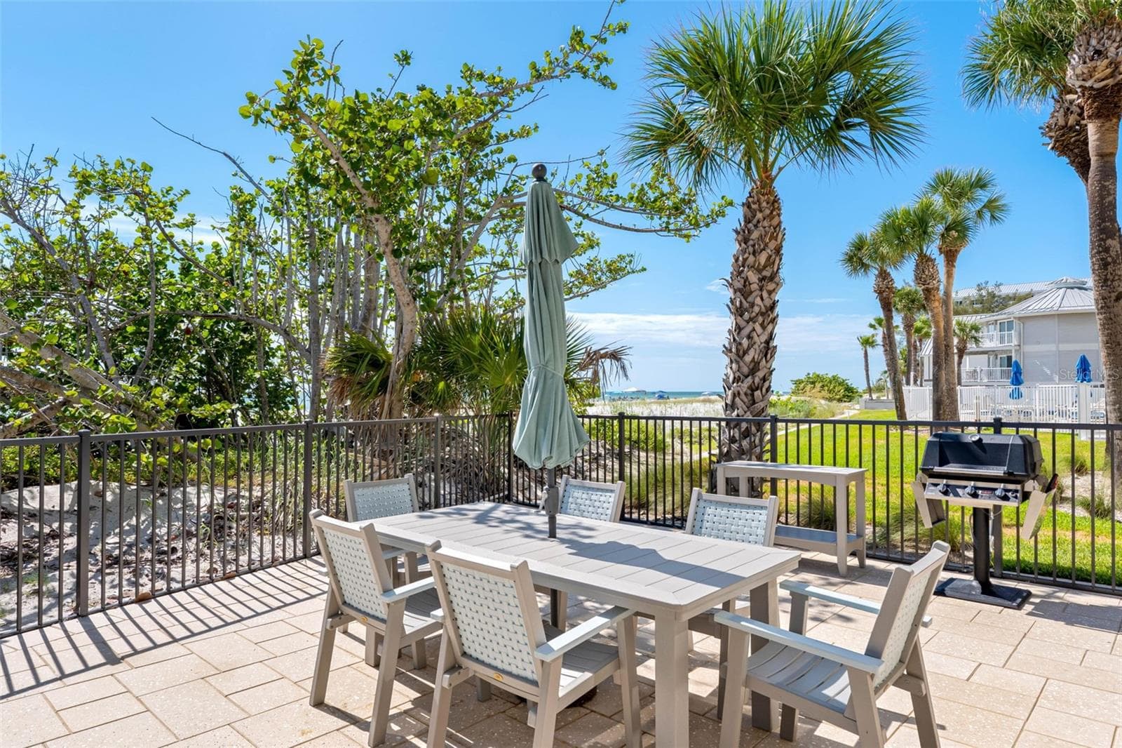 Grilling station on pool deck. - 19700 GULF BLVD #202, INDIAN SHORES