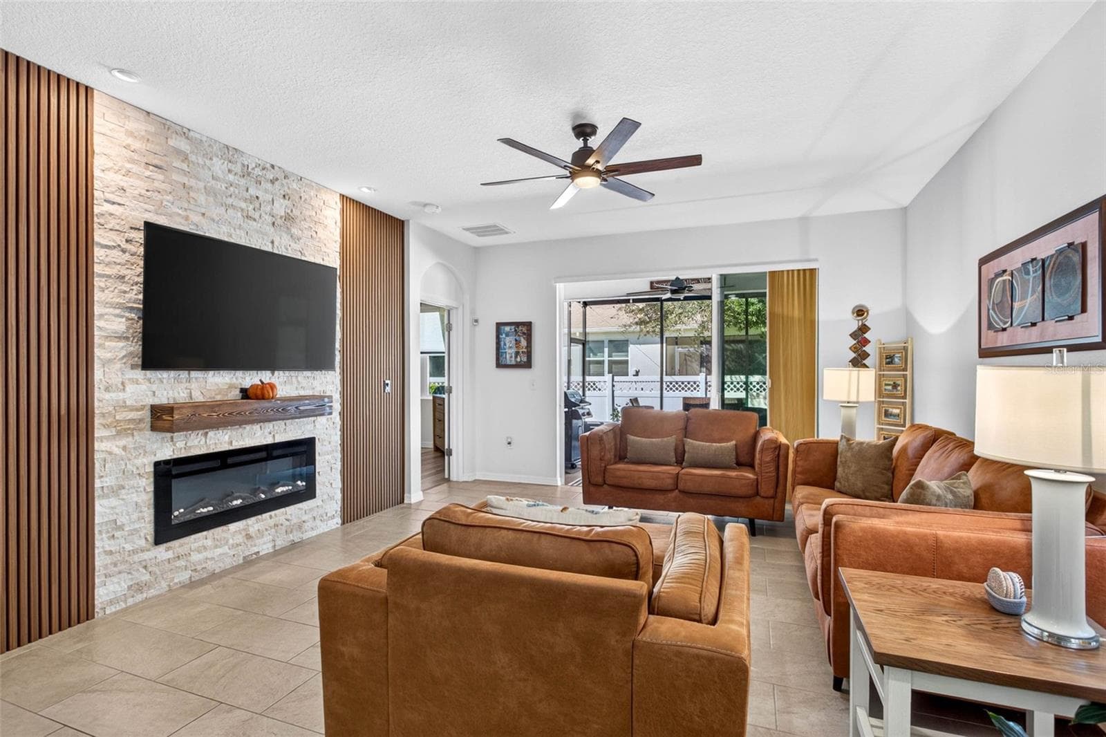 Living room with fireplace/tv wall & ceramic tile flooring. - 32835 WOODTHRUSH WAY, WESLEY CHAPEL