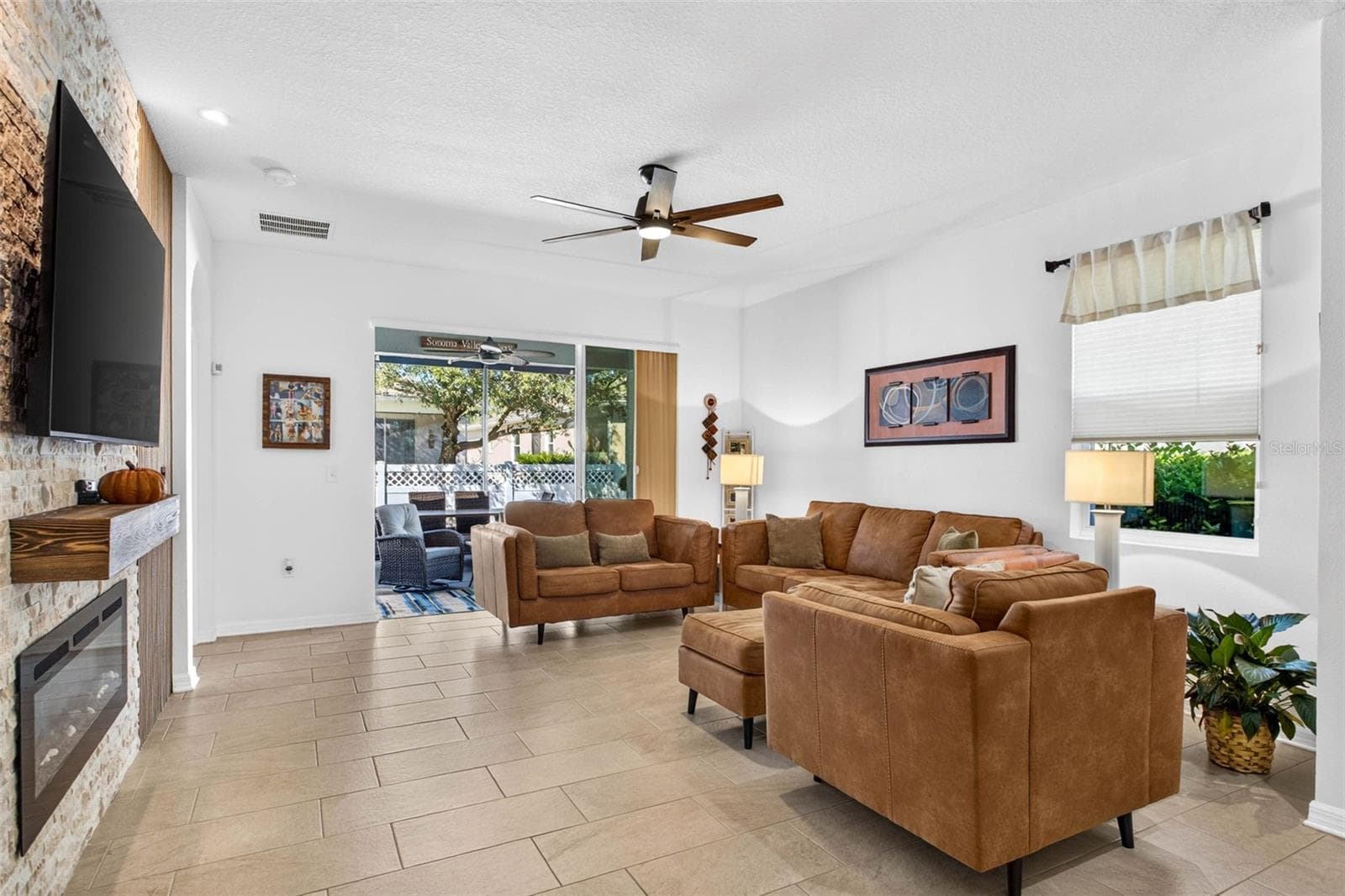 Living room sits by the 3 panel sliders. - 32835 WOODTHRUSH WAY, WESLEY CHAPEL