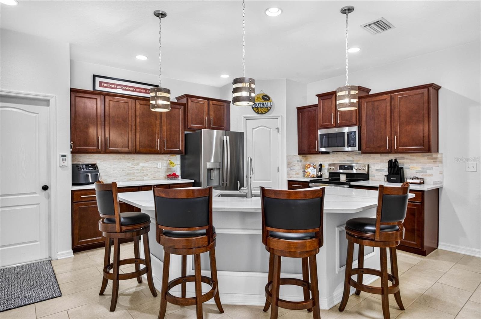Or sit at the island with upgraded countertops. - 32835 WOODTHRUSH WAY, WESLEY CHAPEL
