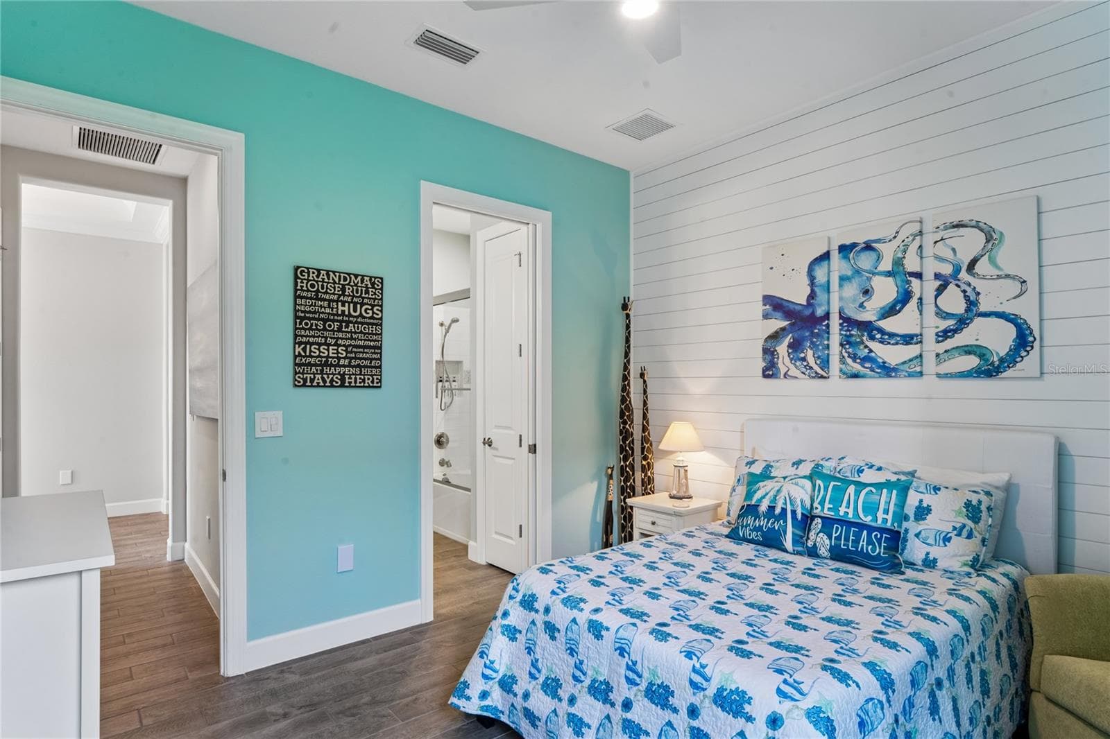 Bedroom 3 w/ en-suite bathroom and shiplap wall feature - 10813 CALLUNA DR, ODESSA