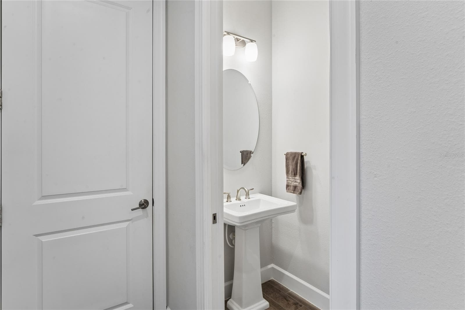 Half bath in hallway leading out to garage - 10813 CALLUNA DR, ODESSA