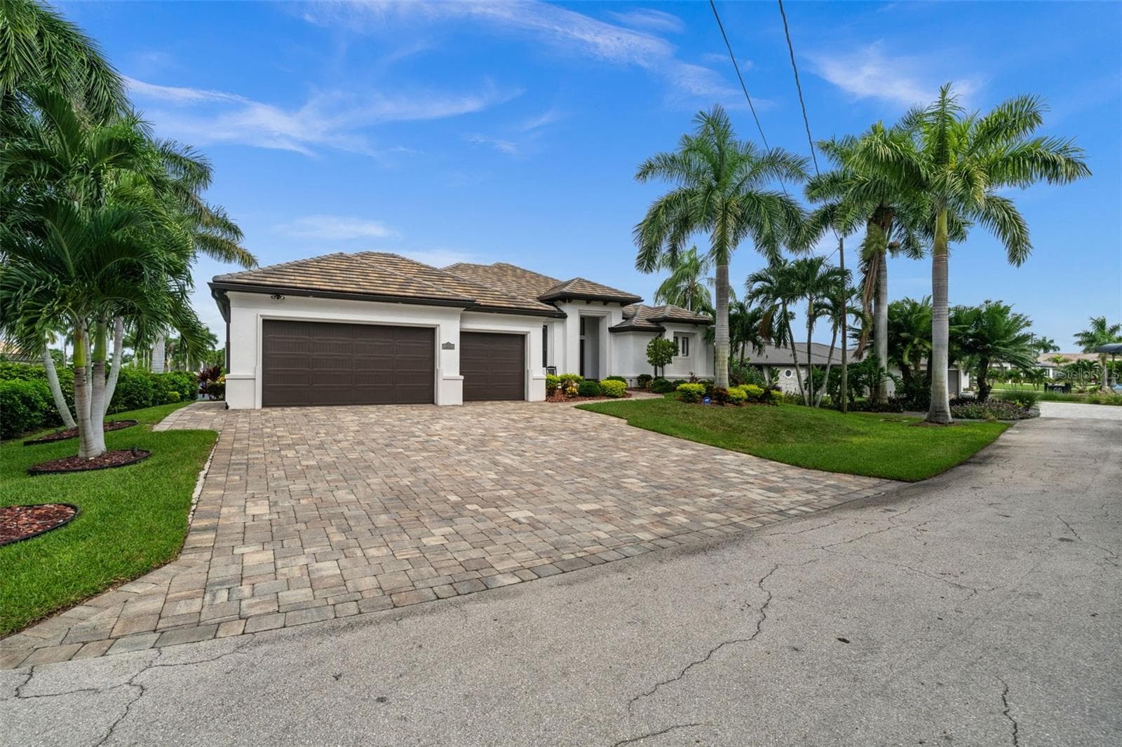 Beautiful Paver driveway leads to the 3 car garage - 5205 SUNSET CT, CAPE CORAL