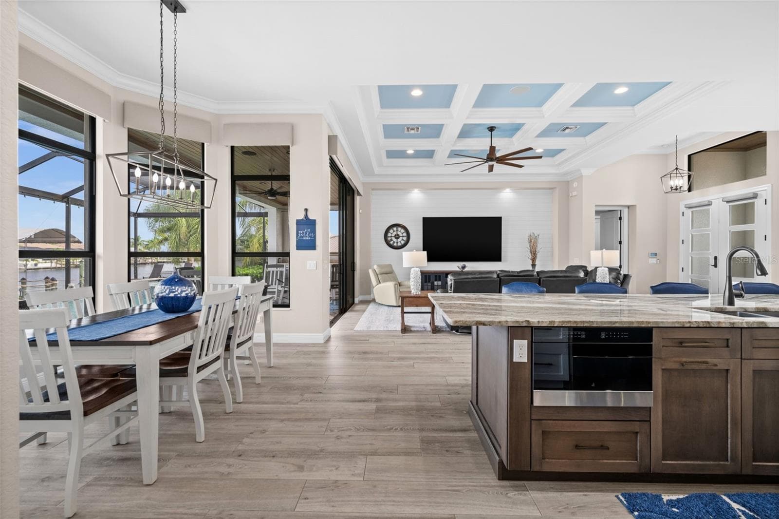 The kitchen overlooks the indoor and outdoor living areas - 5205 SUNSET CT, CAPE CORAL