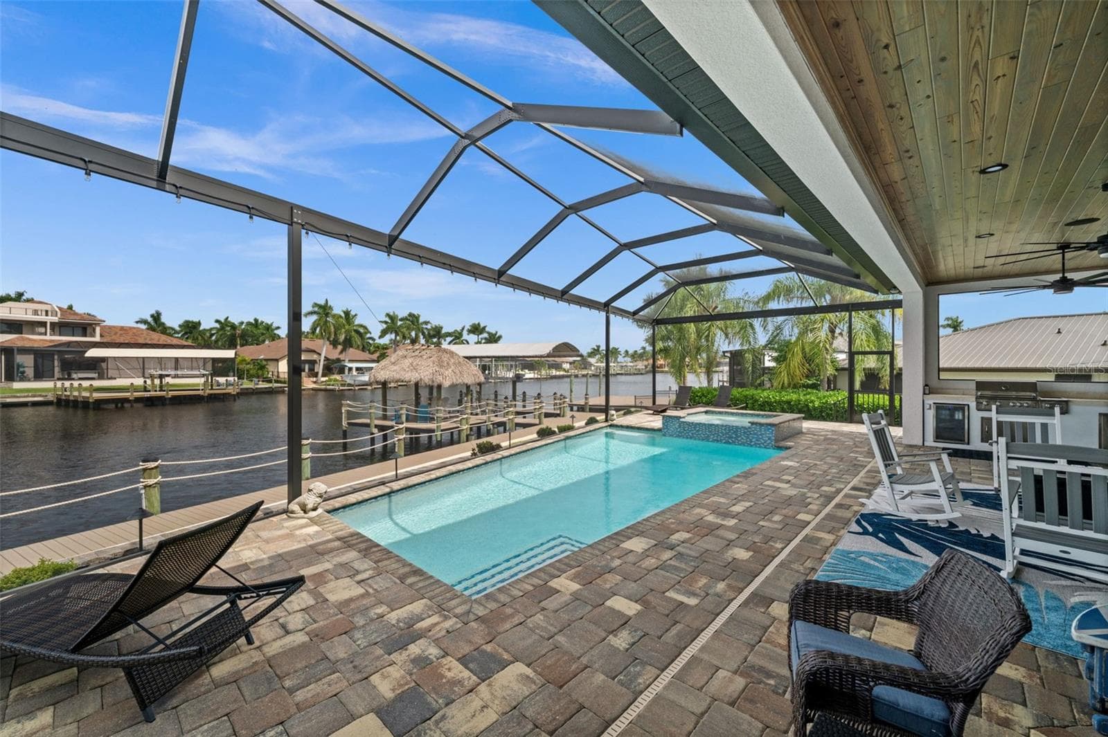 Swim in the heated, saltwater pool while you watch the water - 5205 SUNSET CT, CAPE CORAL