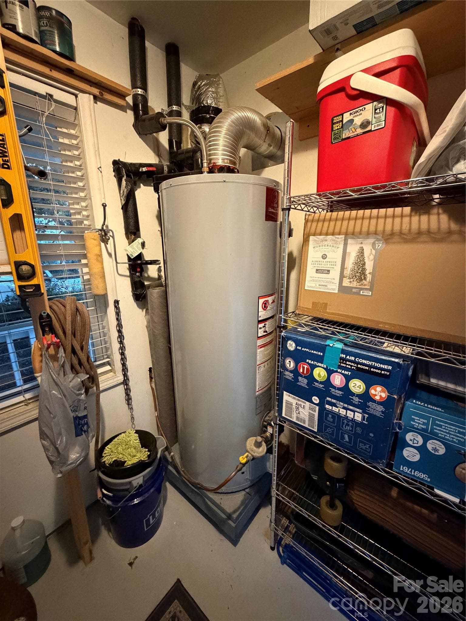 Water heater in storage room attached to the house. - 4126 Medford Drive NW, Concord