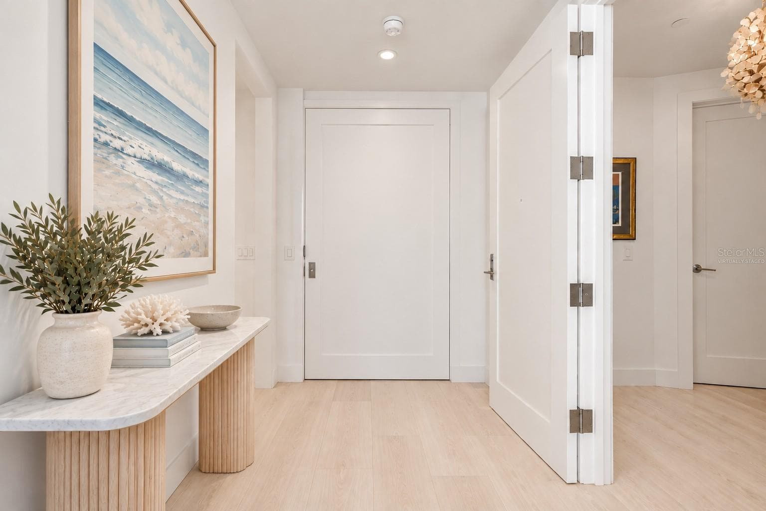 Virtually Staged- Entry Hallway with Pocket Door to Den/Office - 1155 N GULFSTREAM AVE #802, SARASOTA