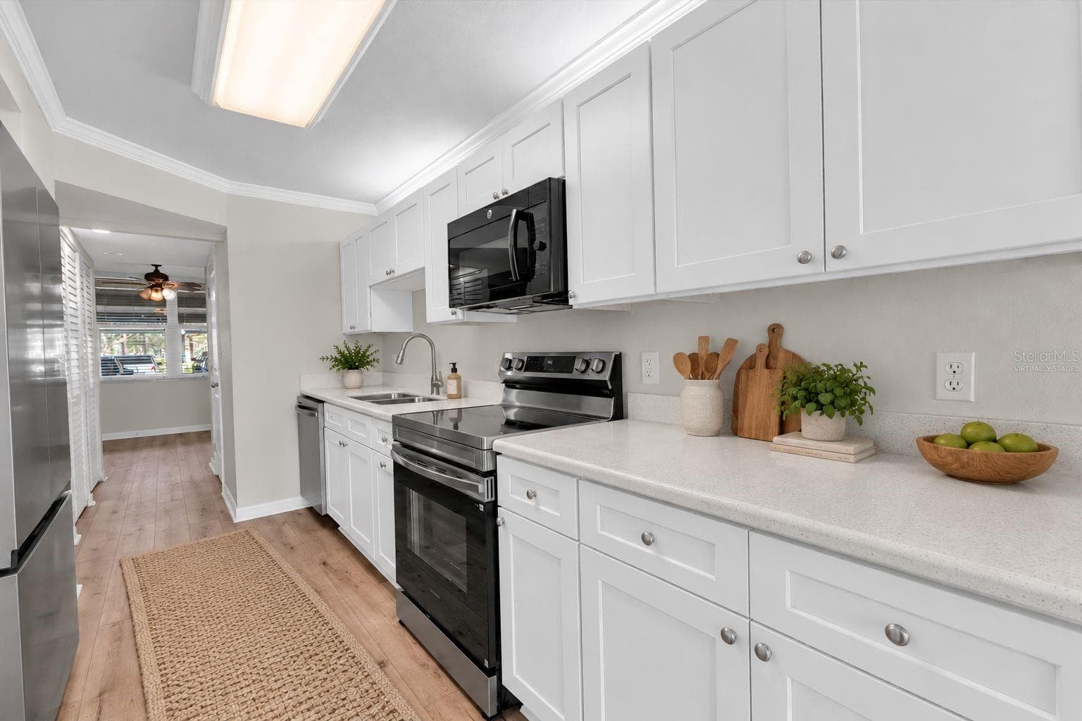 Virtually Staged: Kitchen with New Appliances and Cabinets/Counters - 4885 1ST ST NE #106, ST PETERSBURG