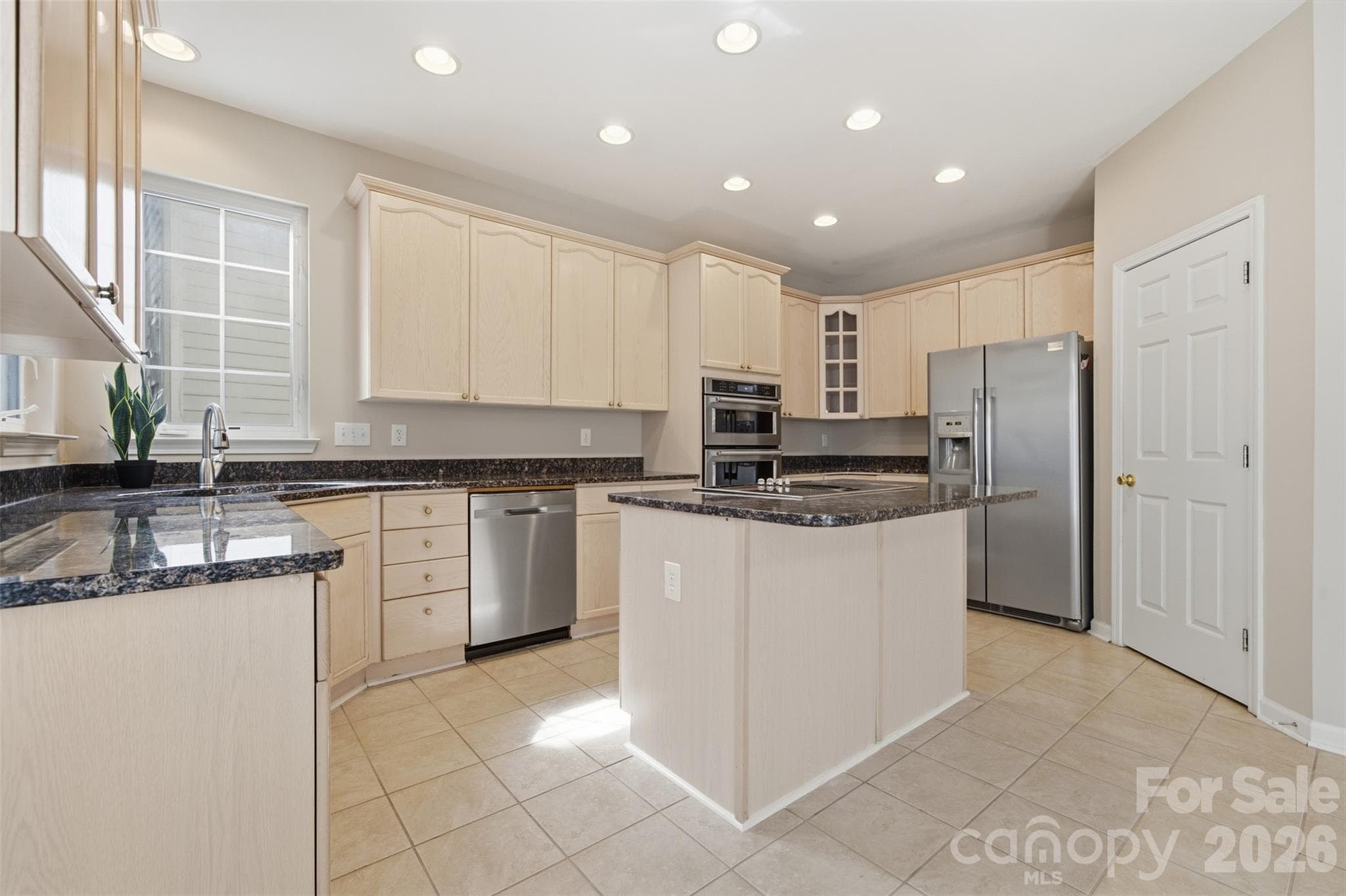 Kitchen with stainless steel appliances, island, and granite countertops - 6211 Chavel Lane, Charlotte