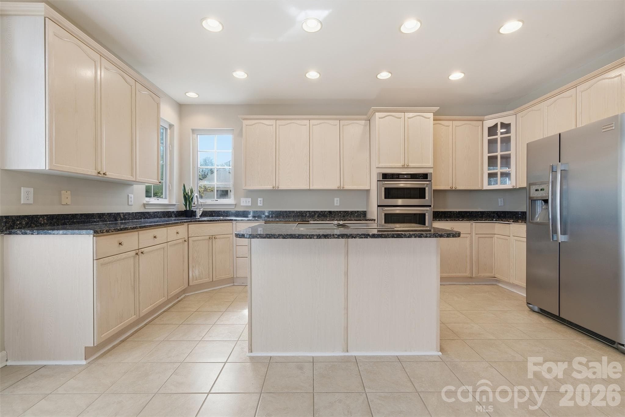 Kitchen with stainless steel appliances, island, and granite countertops - 6211 Chavel Lane, Charlotte